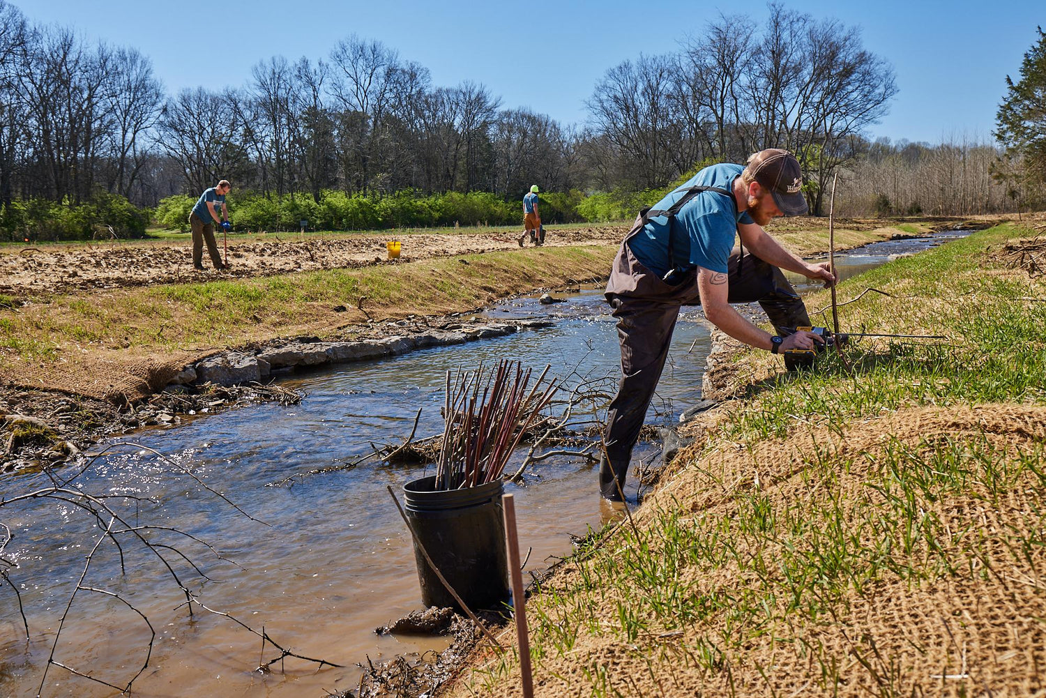 Volunteers working on stream restoration at Stephens Valley for Cumberland River Compact, highlighting efforts in environmental conservation.