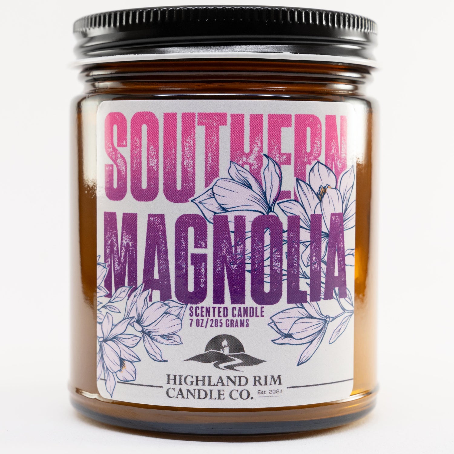 Studio image of Southern Magnolia candle by Highland Rim Candle Co., with a purple label showcasing detailed magnolia flowers, symbolizing Southern grace.