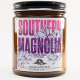 Studio image of Southern Magnolia candle by Highland Rim Candle Co., with a purple label showcasing detailed magnolia flowers, symbolizing Southern grace.